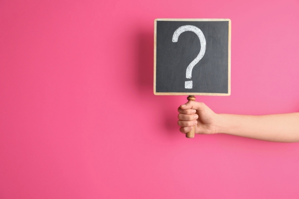 cropped view of a woman's hand holding a question mark sign depicting what you need to know