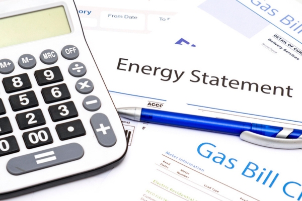 image of energy bill statements with a calculator and pen
