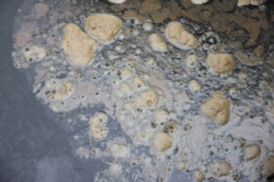 black liquid with solid bubbles depicting heating oil tank sludge