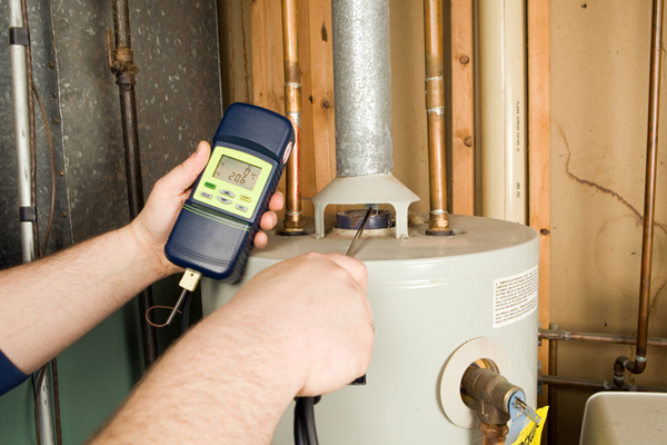 plumber repairing hot water heater in massachusetts by broco energy
