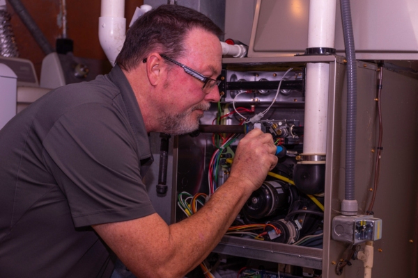 HVAC technician inspecting a furnace