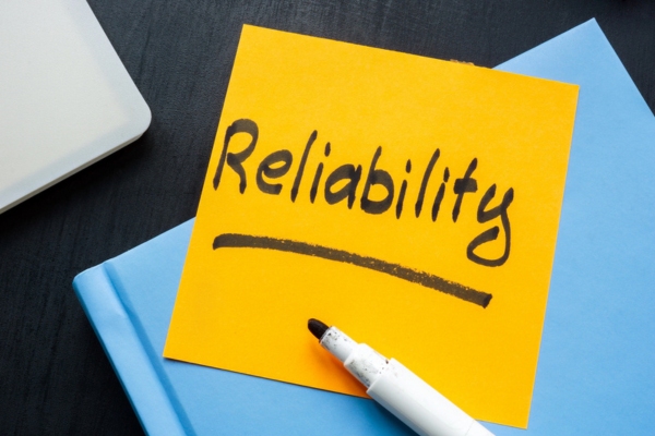 reliability handwritten on a yellow sticky note
