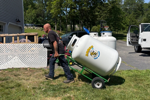 Broco Energy personnel transporting propane tank