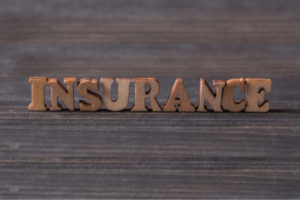 Insurance spelled using 3D wooden letters