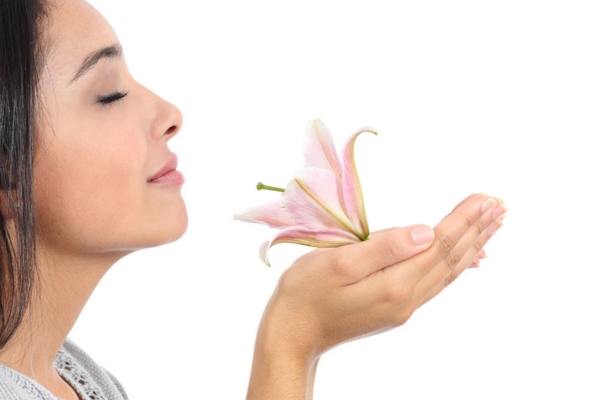 woman smelling a flower on her hand depicting Propane Has No Natural Scent