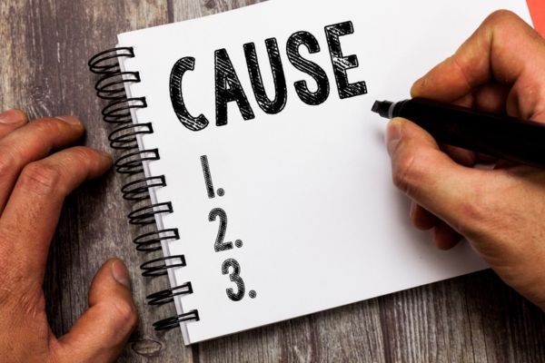 Cause list written on a notepad depicting sludge inside an oil tank