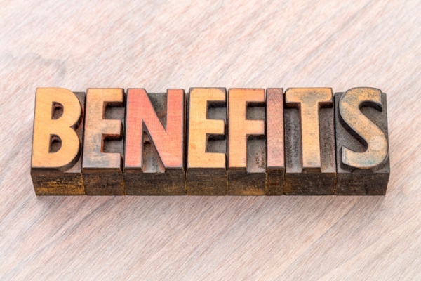 BENEFITS spelled using wooden letterpress
