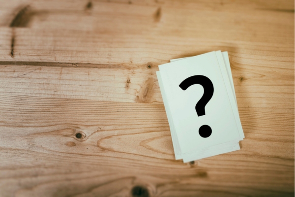 question mark on a stack of paper depicting Propane Tank Landscaping FAQs