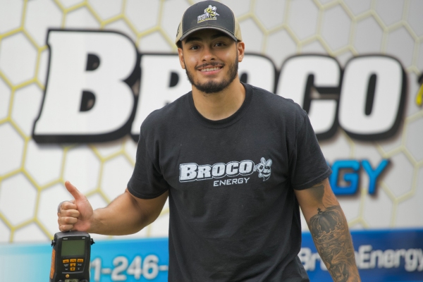 Broco Energy HVAC technician with service van behind