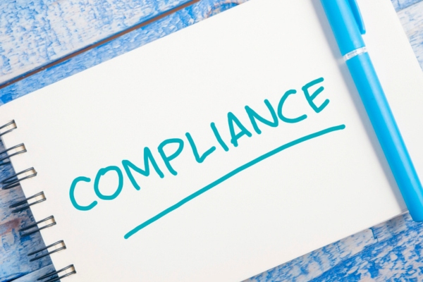 compliance written on a notepad