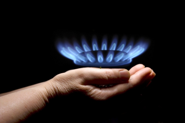 hand holding propane powered stove flame